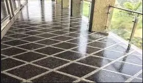 Providing and laying flamed finish Granite stone flooring in required design and patterns, in linear as well as curvilinear portions of the building all complete as per
the architectural drawings with 18 mm thick stone slab over 20 mm (average) thick base of cement mortar 1:4 (1 cement : 4 coarse sand) laid and jointed with cement
slurry and pointing with white cement slurry admixed with pigment of matching shade including rubbing , curing and polishing etc. all complete Flamed finish granite stone slab Jet Black, Cherry Red, Elite Brown, Cat Eye or equivalent